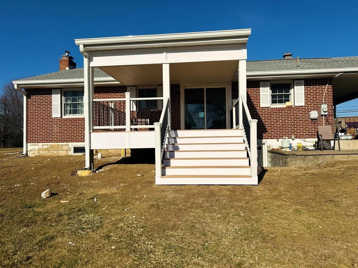 Covered porch roof framing over a composite deck