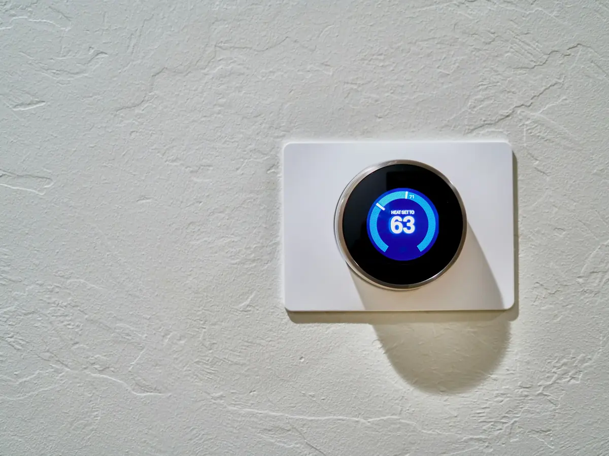 A wall thermostat set to heat