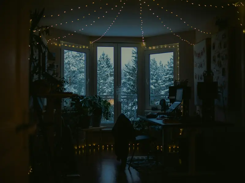 A warm room with snow outside the windows