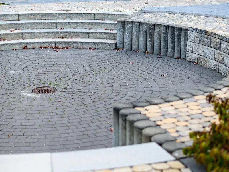 Curved seating area with stone steps and paver bands