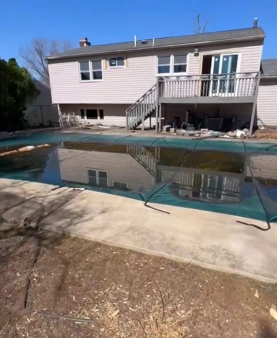 Backyard with old in-ground pool before demolition down to subgrade