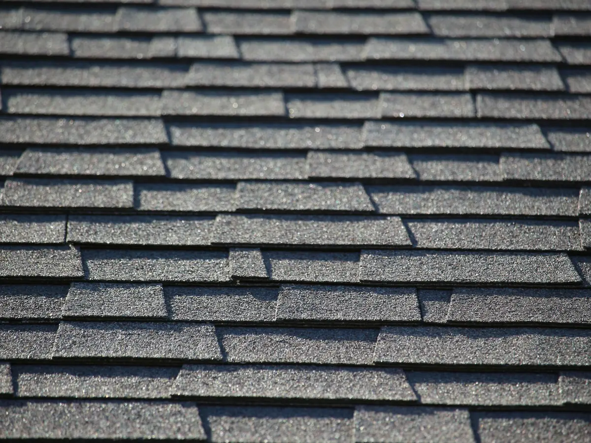 Close-up of straight courses of dark grey asphalt shingles