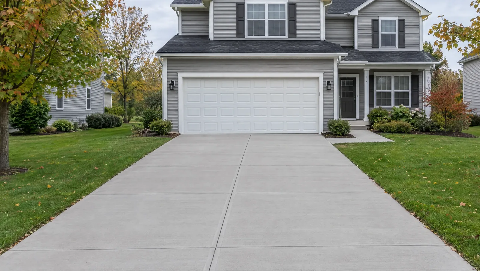 A two-story Lake County house with a new broom-finish concrete driveway