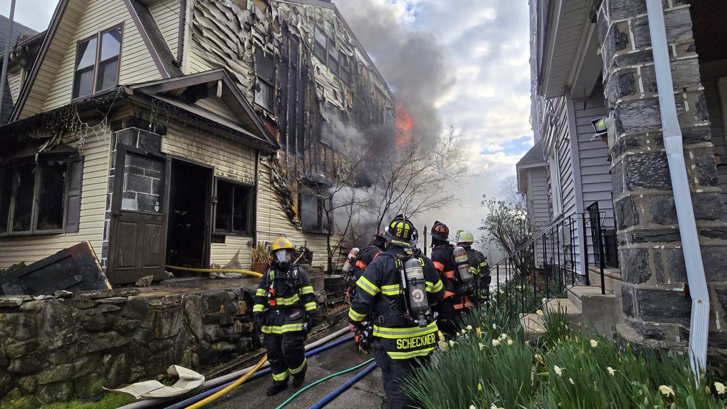 CHFC firefighters in full SCBA advancing on a working structure fire